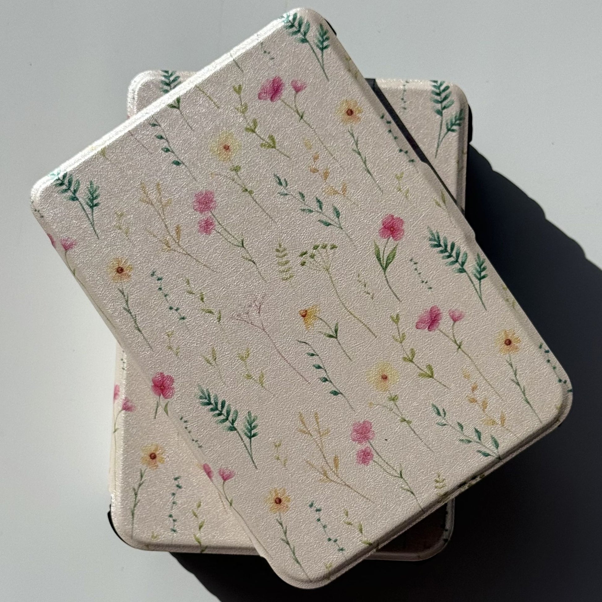Spring Court Kobo Libra cases overlapping in cream with pink and yellow pressed flowers, ferns and watercolour wildflower print — bookish ereader cover