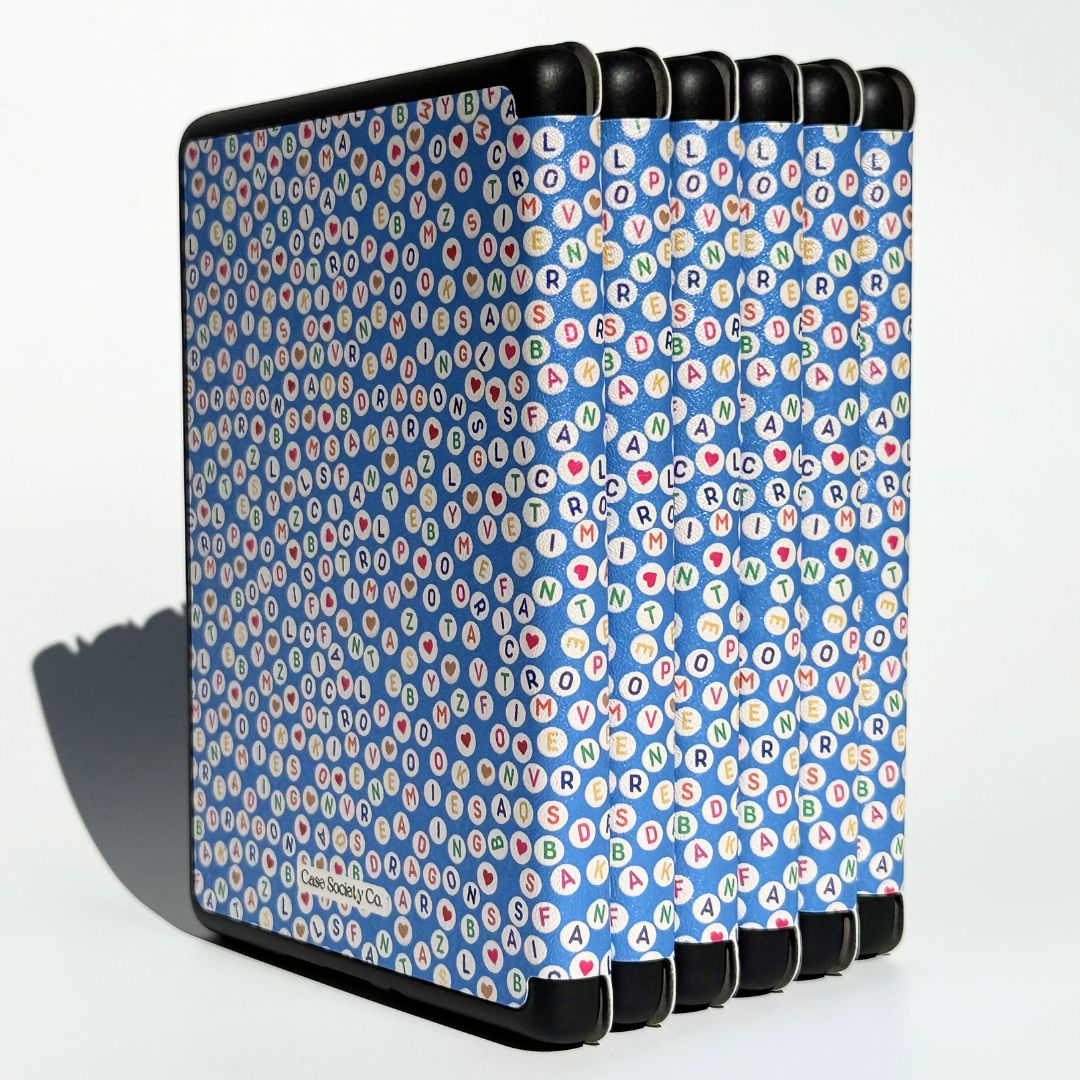 Stacked Swiftly Written Kindle cases front and back, blue letter bead pattern with hearts