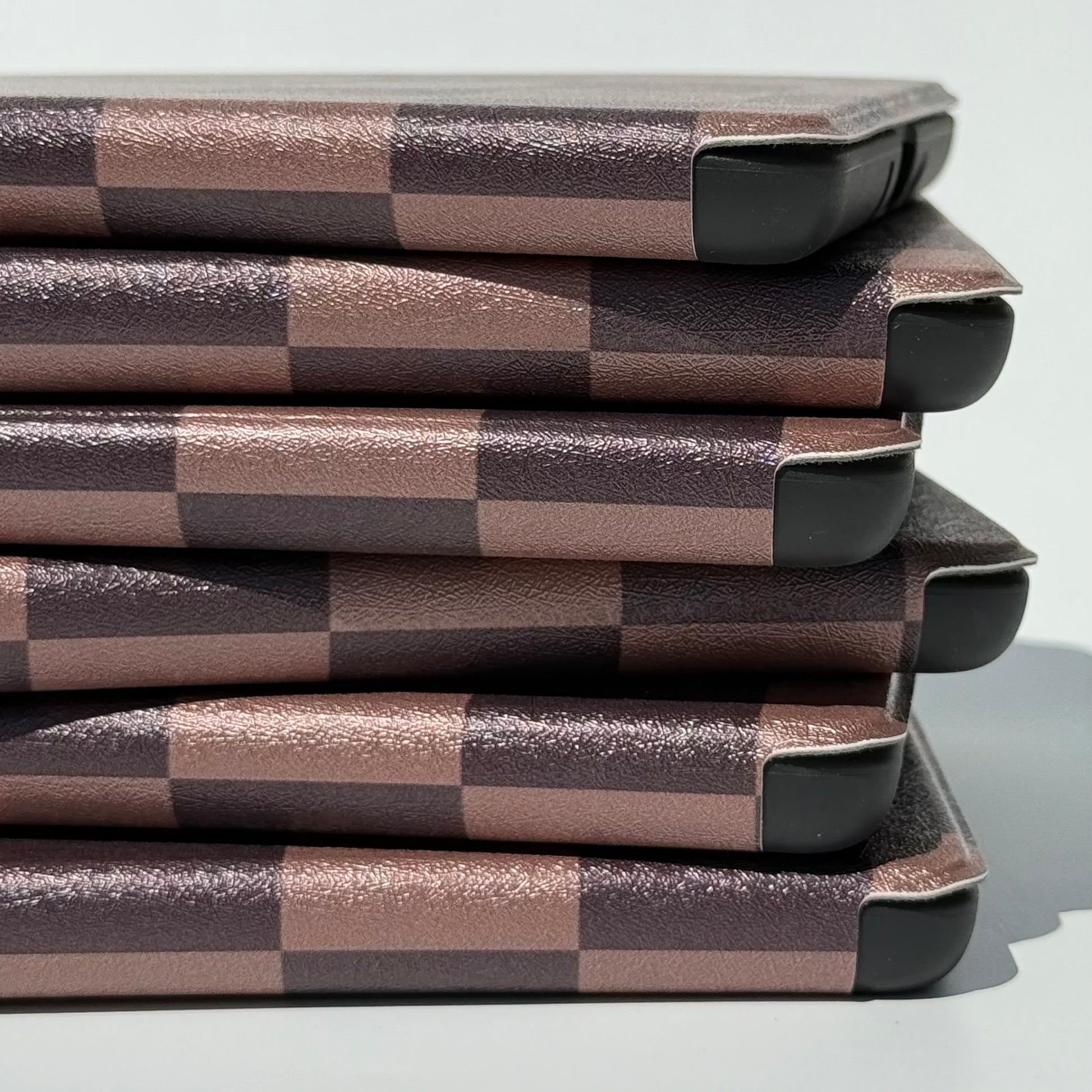 The Dreamer Kindle Case by Case Society up close of the spines and corners of a stack of cases