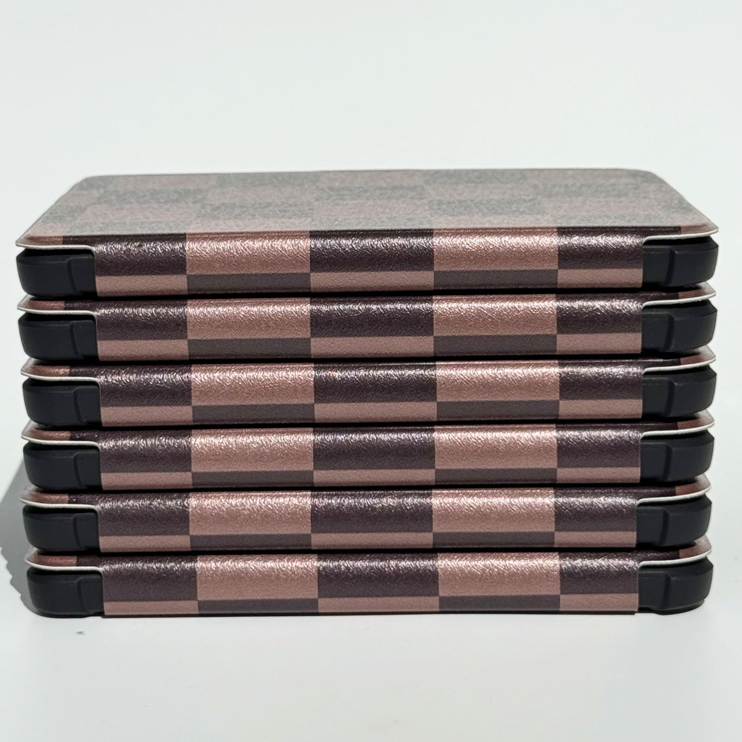 Side profile of The Dreamer Kobo Libra cases stacked, mocha checkerboard pattern with shockproof bumper