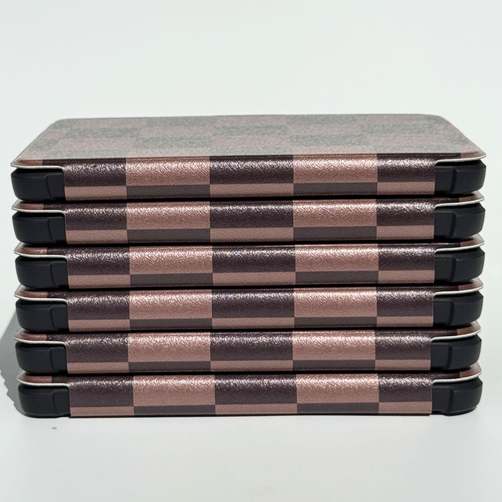 Side profile of The Dreamer Kobo Libra cases stacked, mocha checkerboard pattern with shockproof bumper