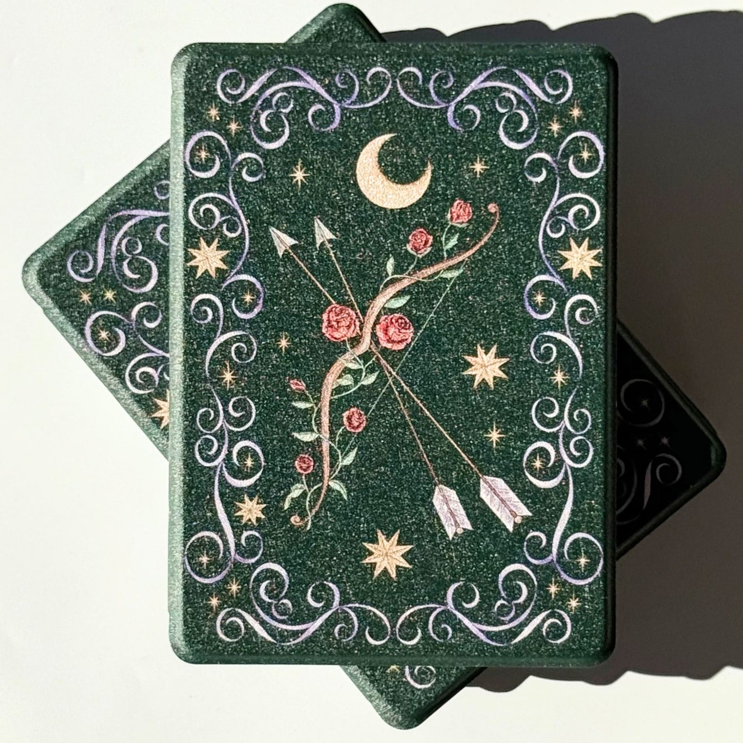 Two The Huntress Kindle cases, forest green fae aesthetic with gold moon and stars