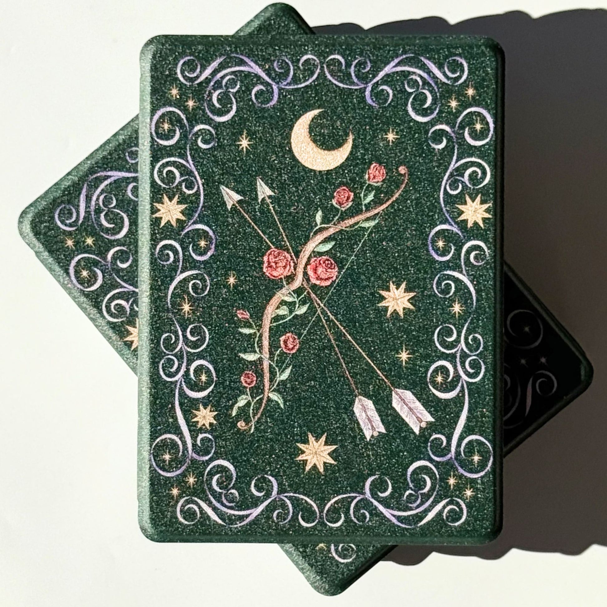 Two The Huntress Kindle cases, forest green fae aesthetic with gold moon and stars