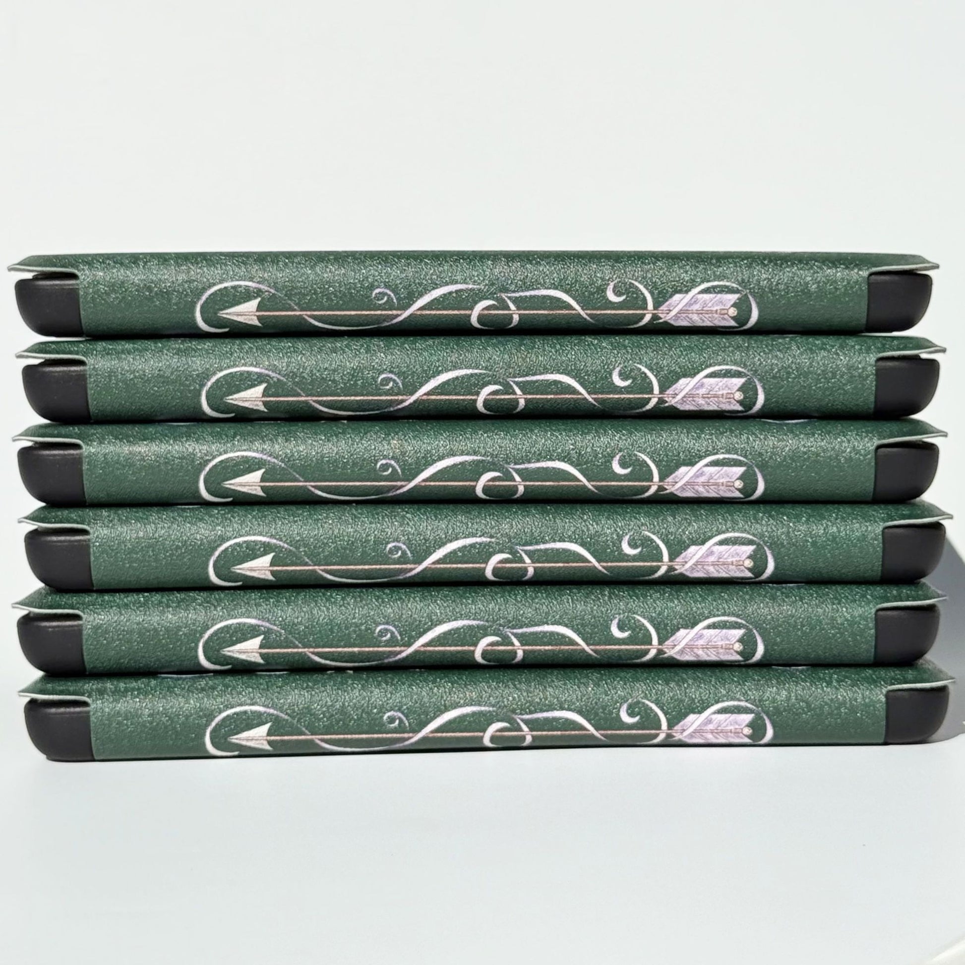 Spine detail of The Huntress Kindle cases, silver arrow and vines on emerald green