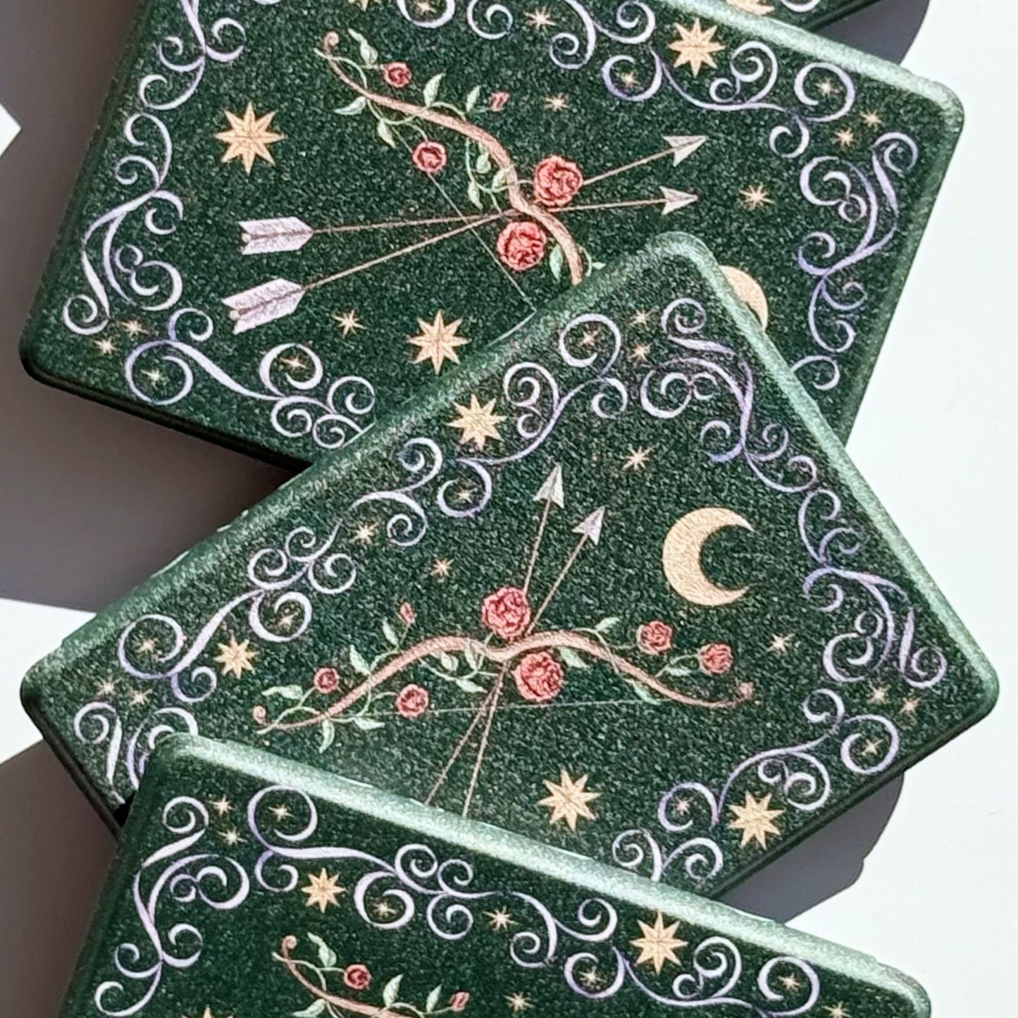 The Huntress green Kindle cases fanned out, aesthetic romantasy bow and roses, Case Society Australia