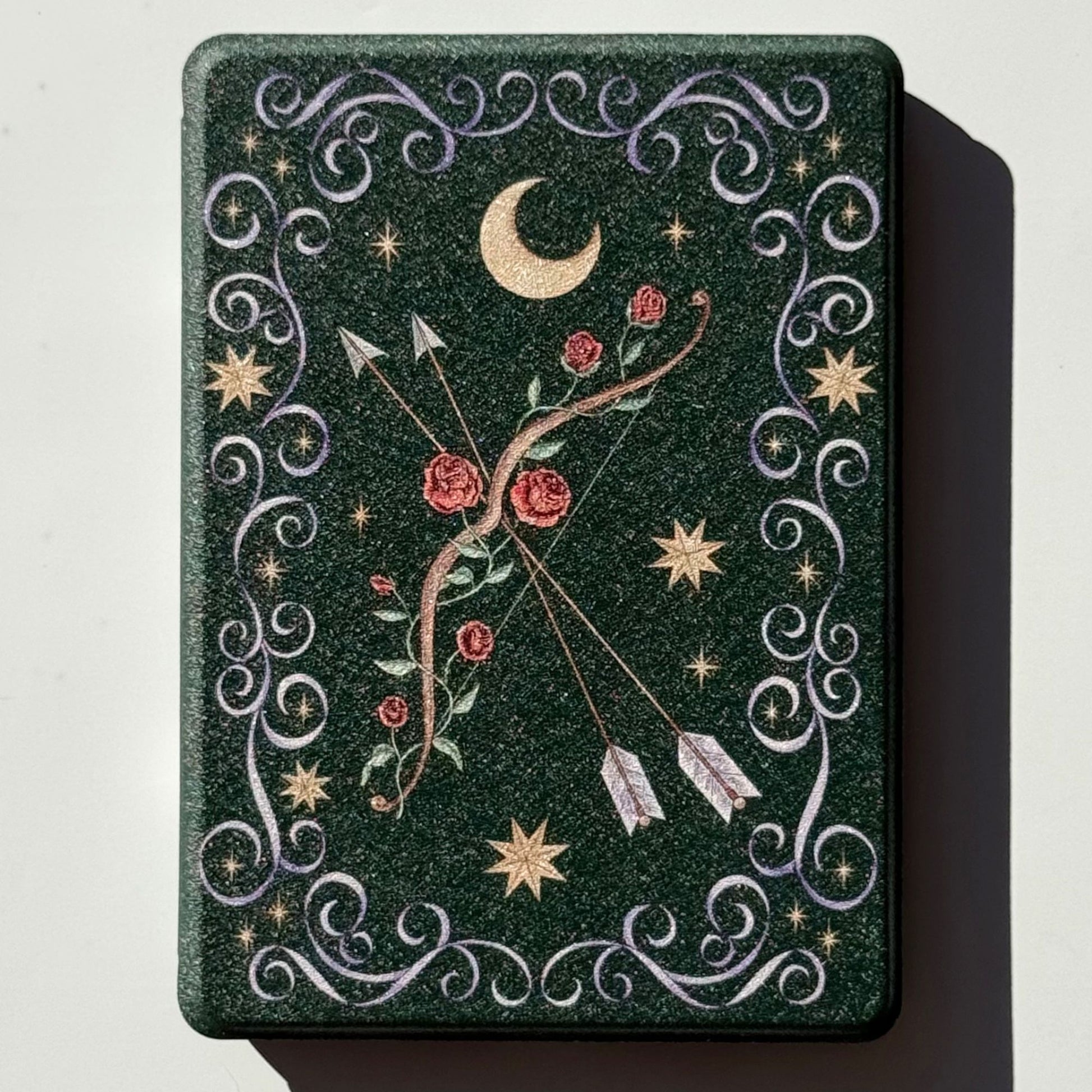 The Huntress green Kindle case, hand-drawn rose-entwined bow, gold moon and stars, romantasy design