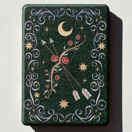 The Huntress green Kindle case, hand-drawn rose-entwined bow, gold moon and stars, romantasy design