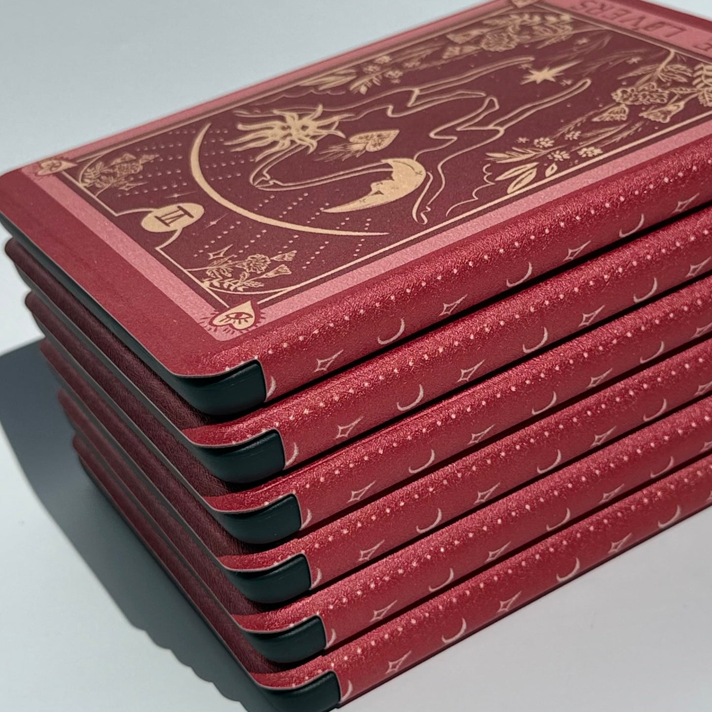 Stack of The Lovers Kindle cases at an angle showing reinforced protective corners — aesthetic Kindle case AU