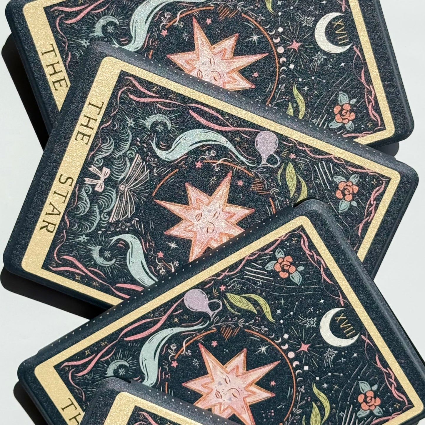 The Star Kindle cases fanned out to show the full tarot illustration on every cover