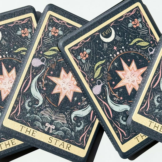 The Star Kindle cases fanned out like a dealt tarot spread, showing the crescent moon and celestial detail