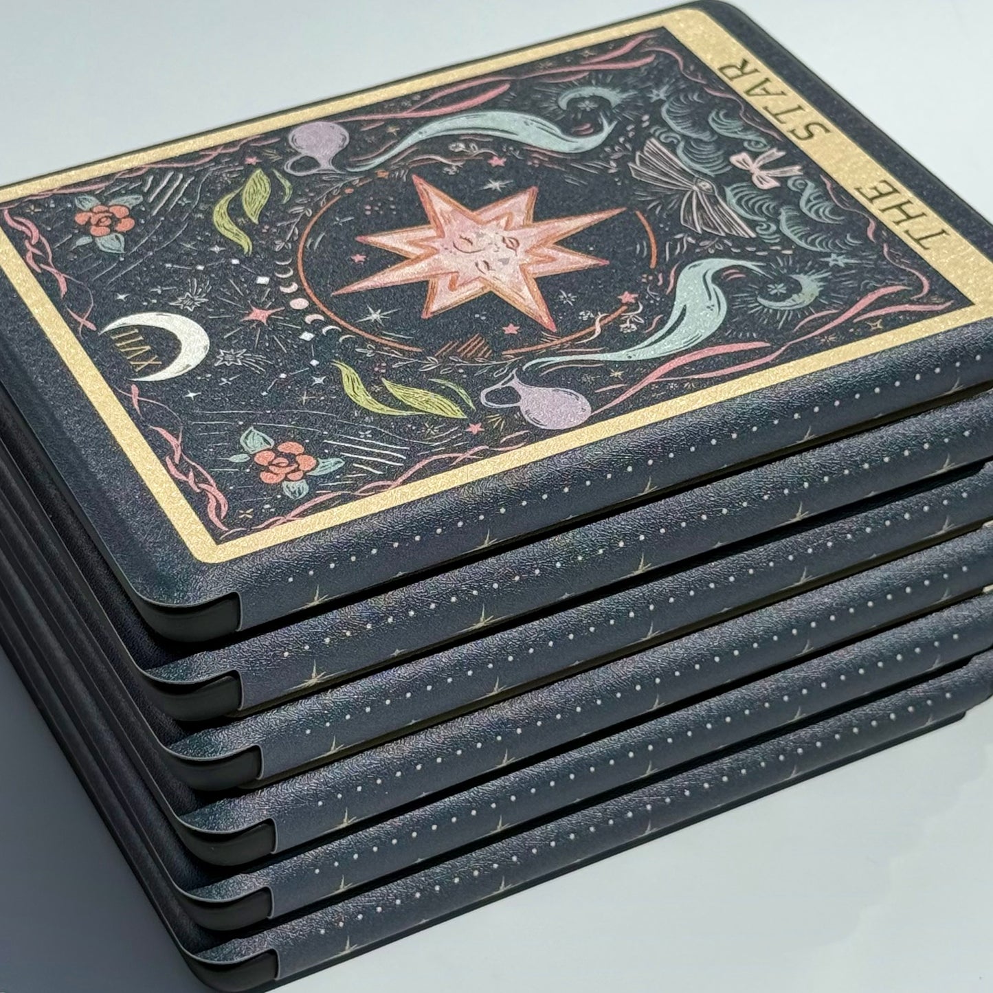 The Star Kindle case shown at an angle, its gilt border and star illustration catching the light