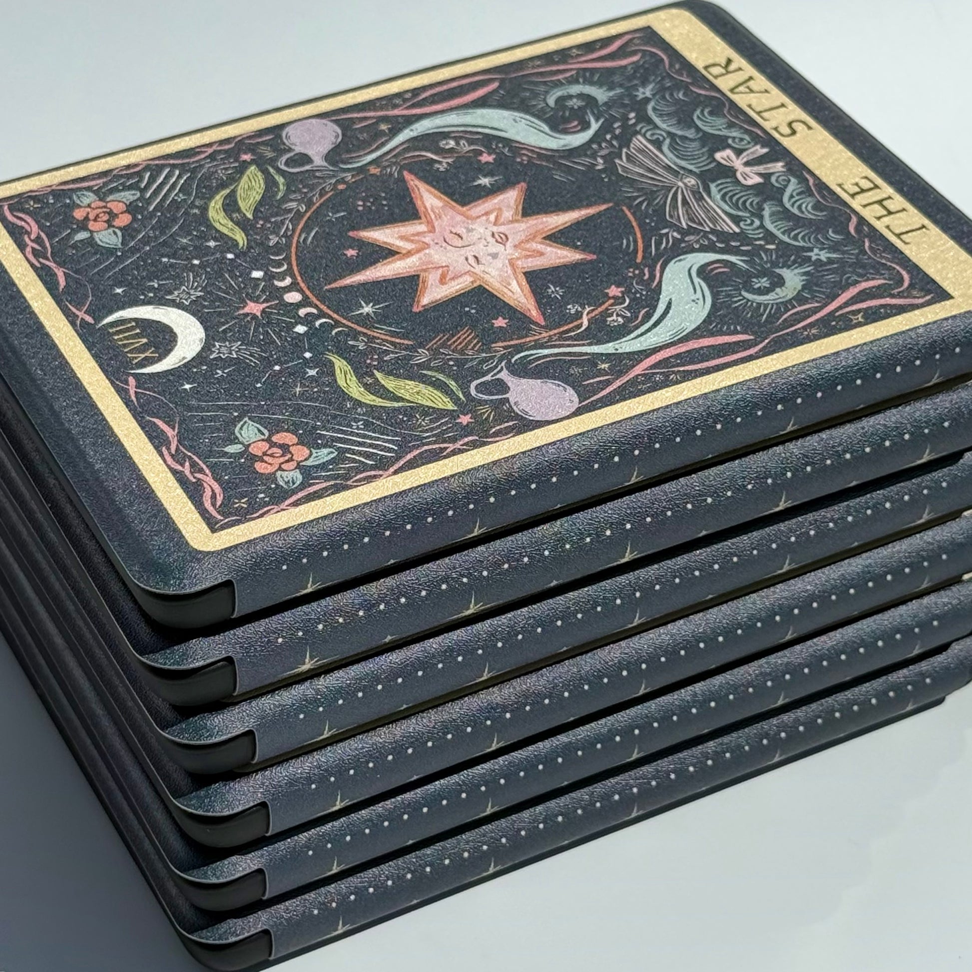 The Star Kindle case shown at an angle, its gilt border and star illustration catching the light