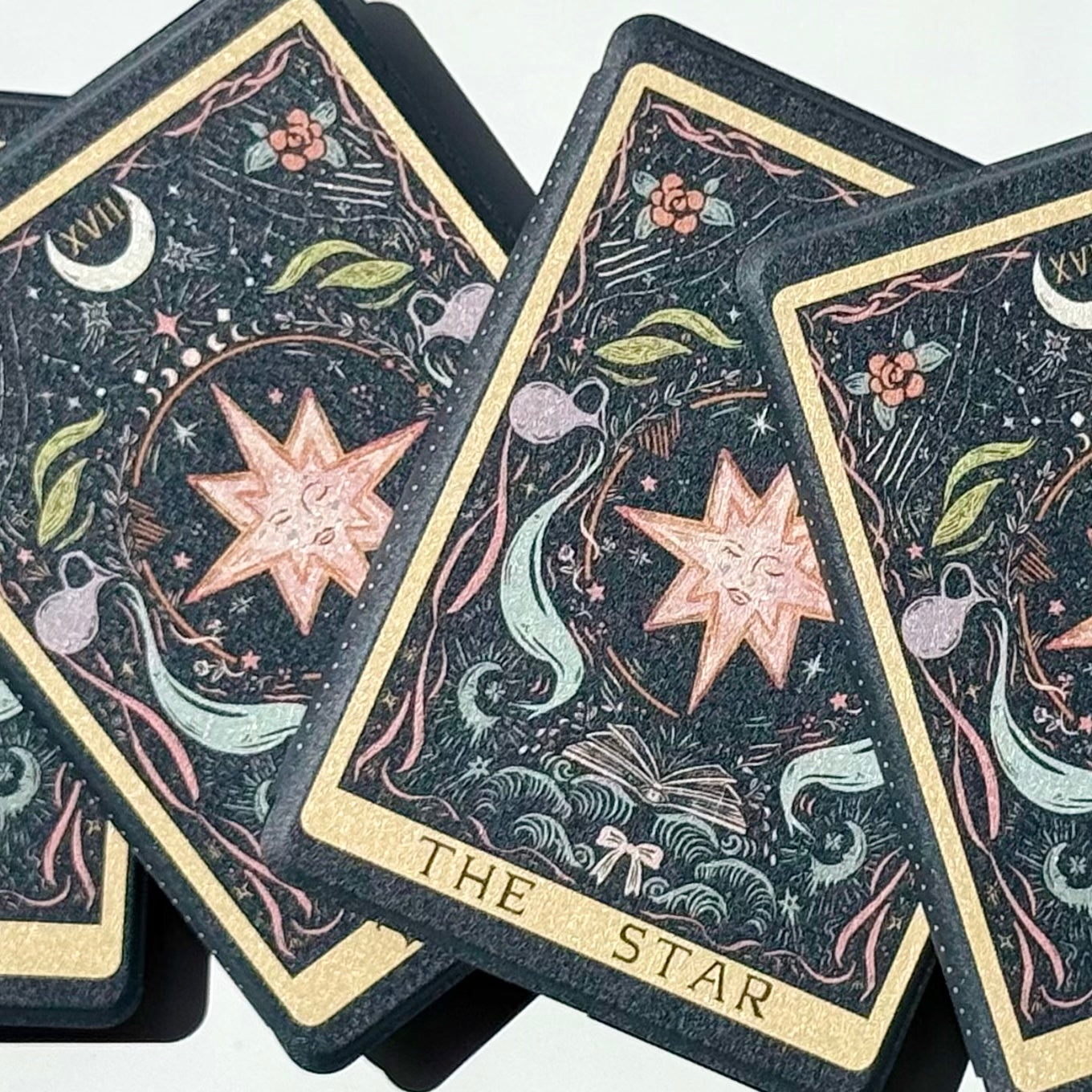 Four Kindle cases fanned together, each printed with The Star tarot art