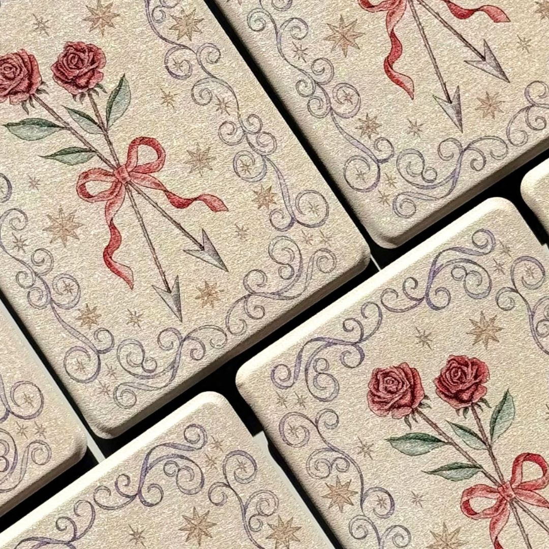 Flatlay of cream romantasy Kindle cases with lilac filigree borders and gold stars