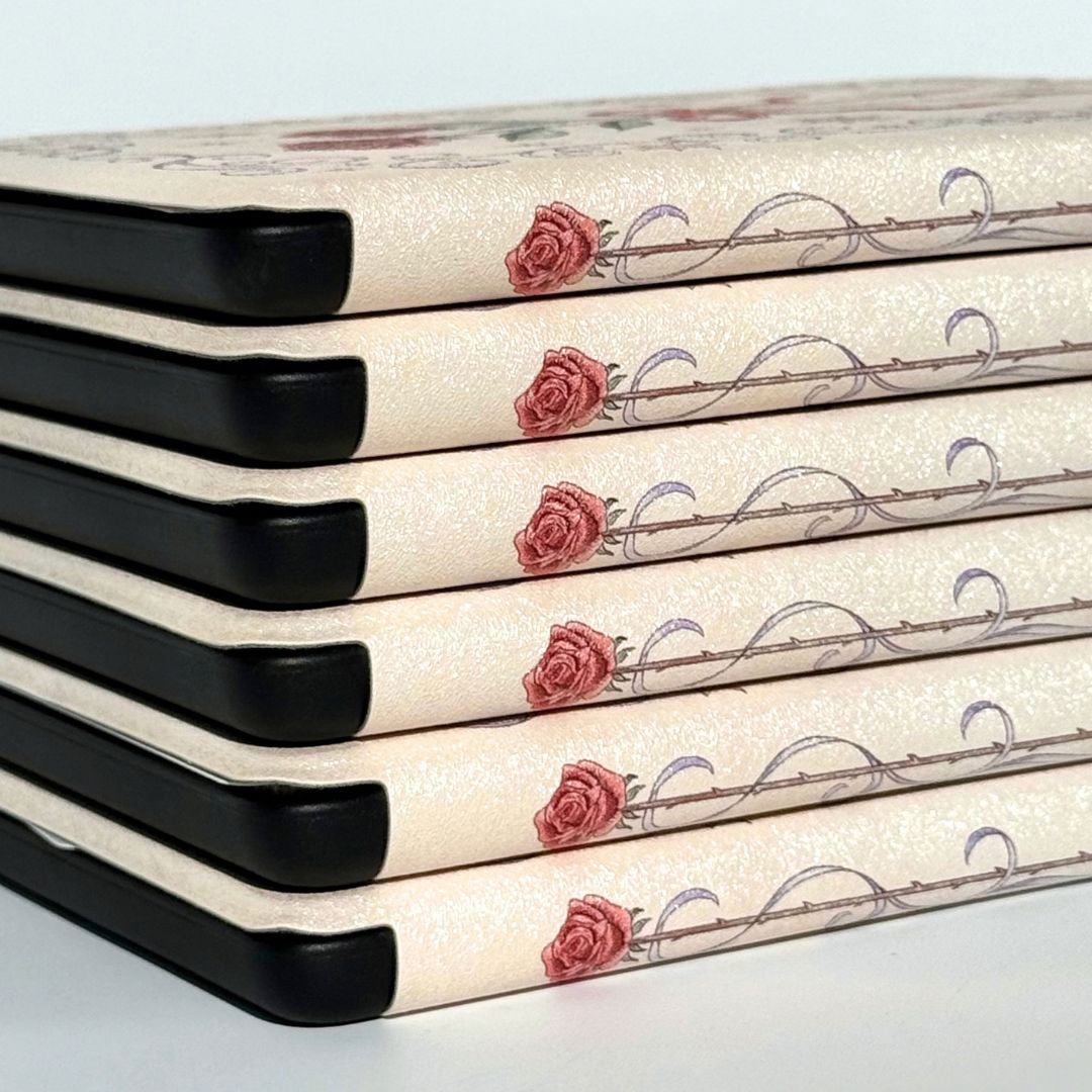 Close-up of the rose spine on The Vow Kindle case, cream shimmer finish