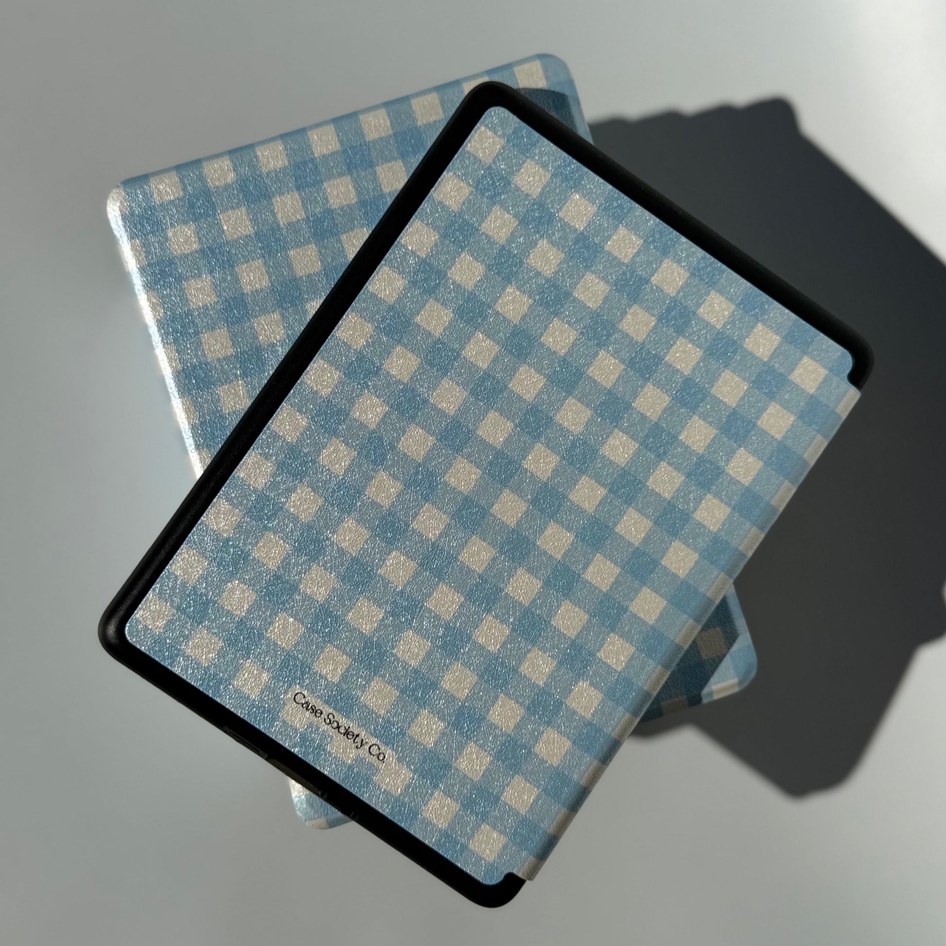 Back of The Quiet Blue Kindle case showing blue gingham print and rounded corners