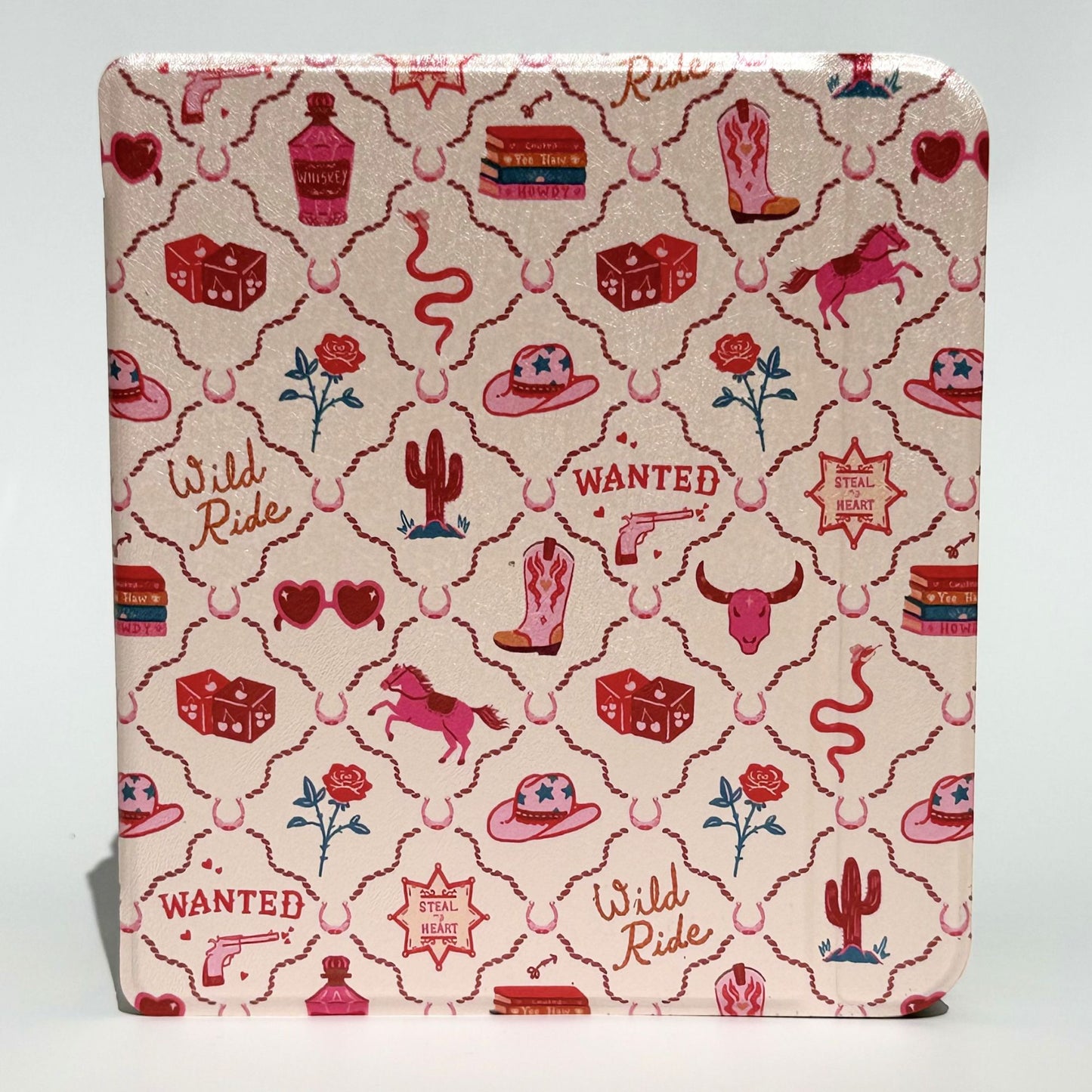 Angled stack of Wild Ride Kobo Libra cases showing pink cowboy print with hats, boots, horses, cacti, roses and dice — Case Society Co.