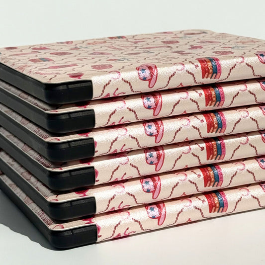 Wild Ride Kobo Libra case in pink with western print — cowboy hats, cacti, horses, roses and 'Wild Ride' text on cream background