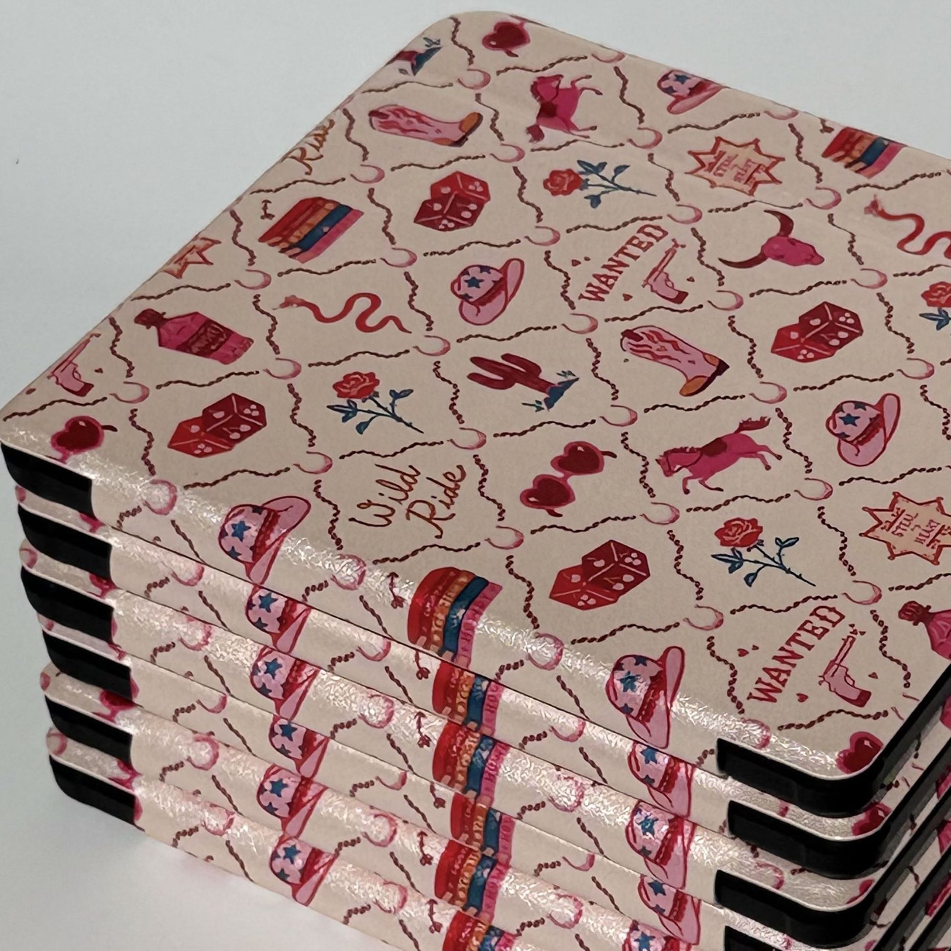 Stacked Wild Ride Kobo Libra cases viewed from above and side, pink western print with horses, cowboy hats and 'Wild Ride' text